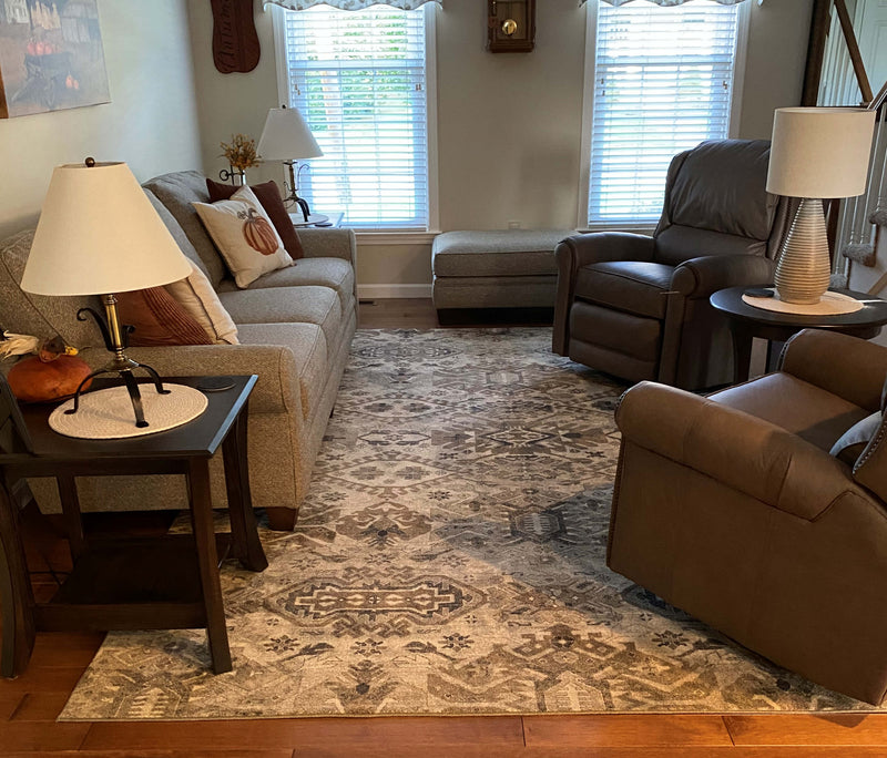 Richmond area rug used in a living room setting with brown leather furniture